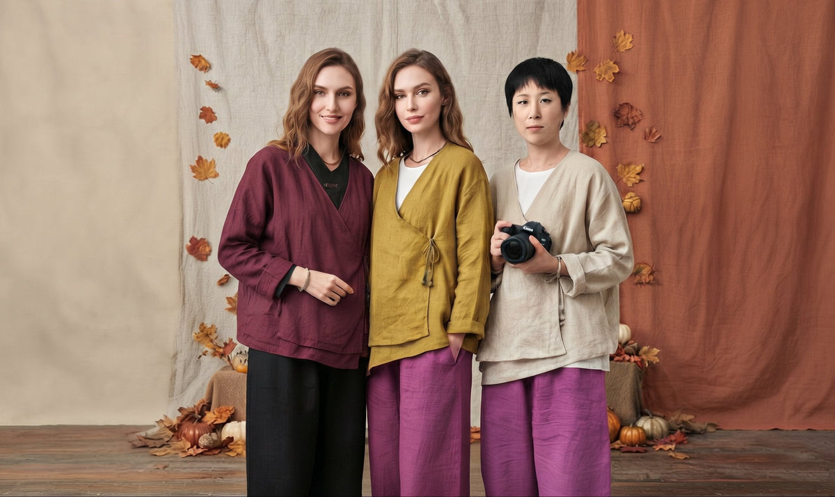 three women wearing boho-style linen clothing, including long-sleeve button-up shirts and wide-leg trousers in rich fall colors like burgundy, mustard yellow, and beige, standing against an autumn-themed backdrop.