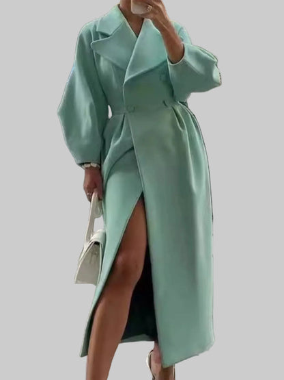 Person wearing a light green coat on a city street.