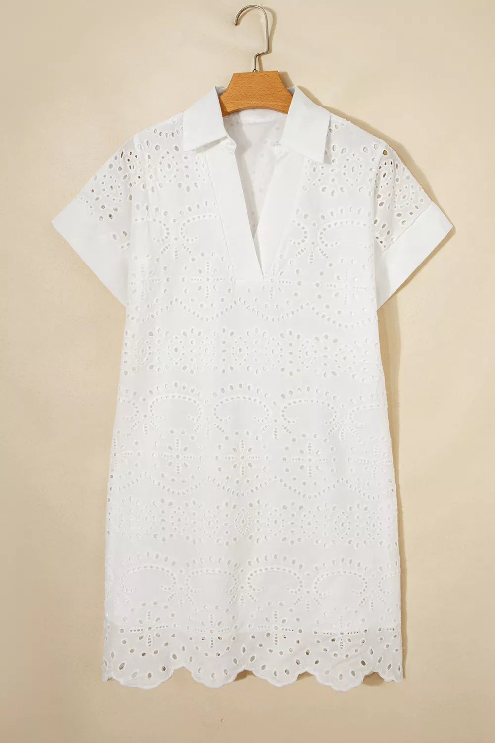White lace dress on a beige background