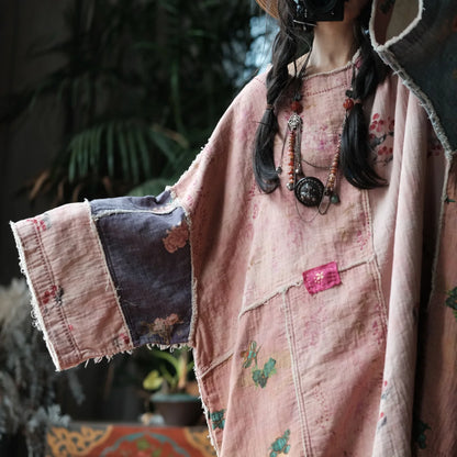 Person wearing a patchwork coat with floral patterns and embroidery.