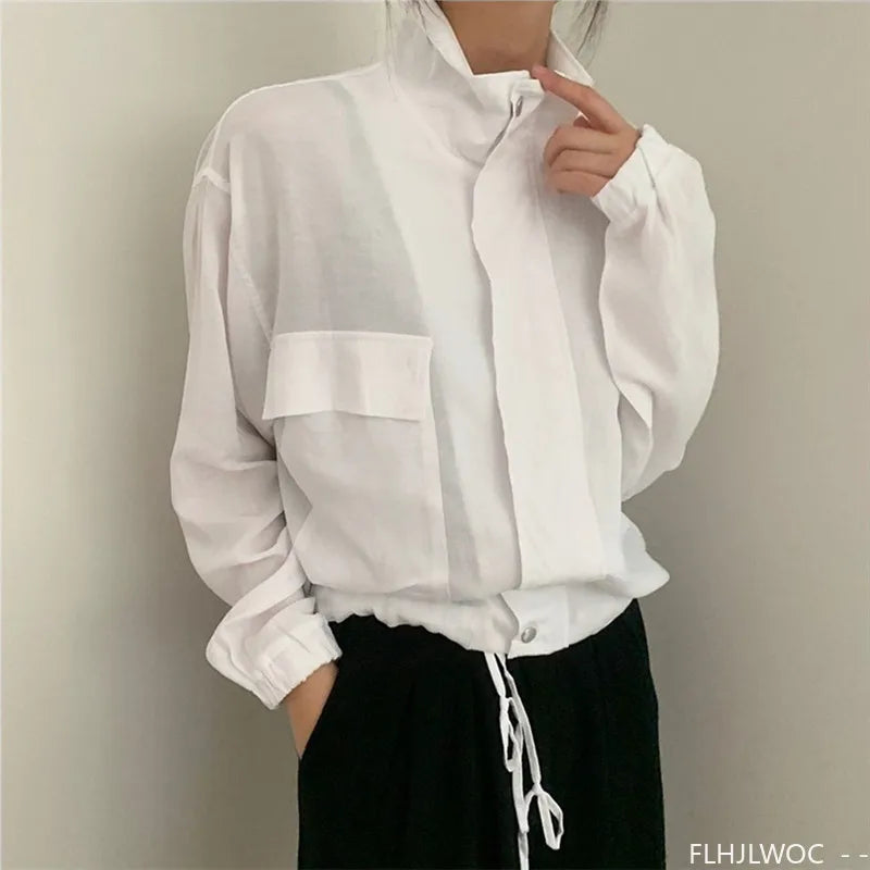 White shirt with a pocket and drawstring on a plain background
