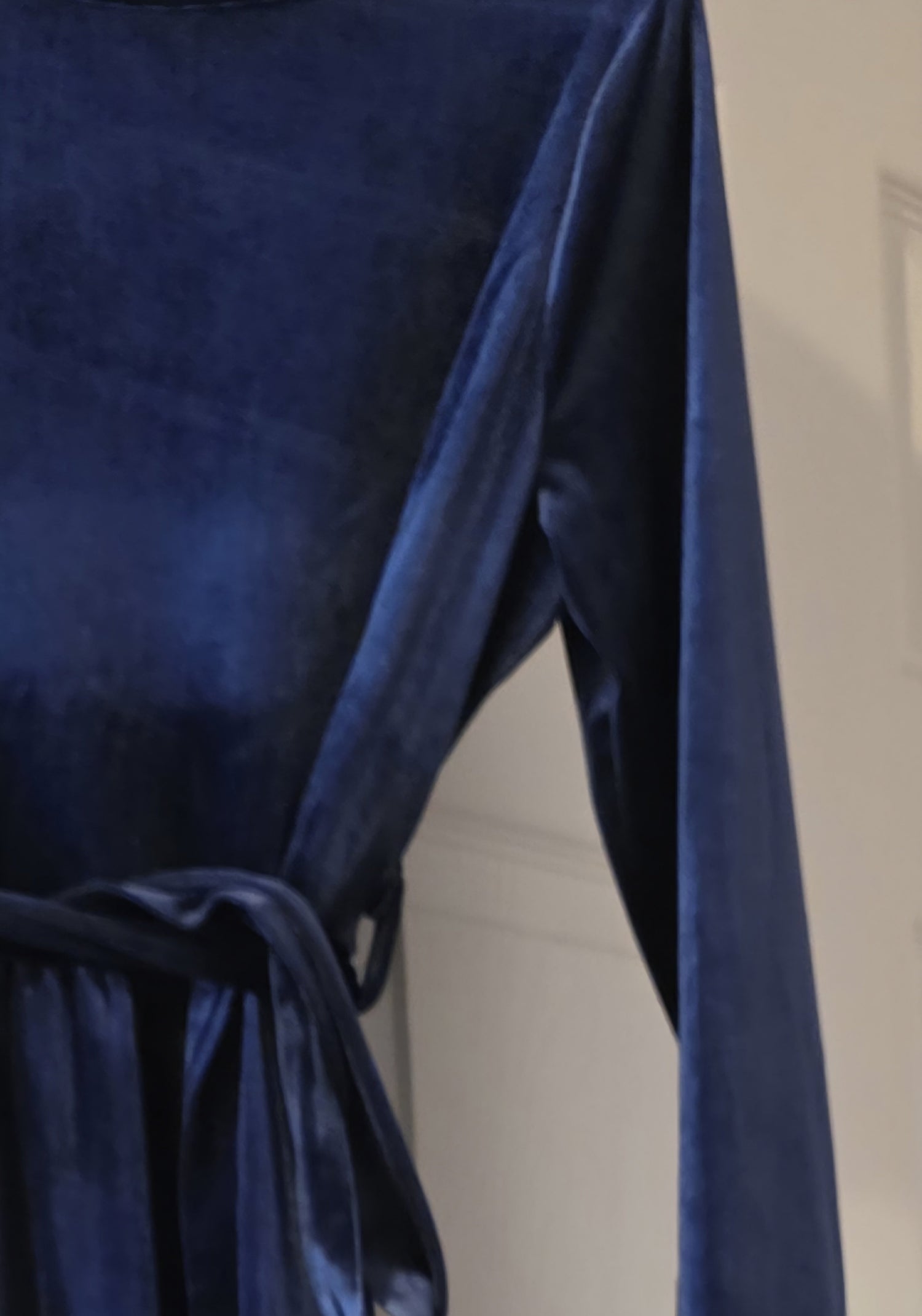 Navy blue dress with a close-up of the fabric texture.