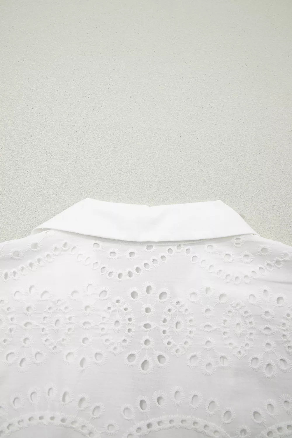 White lace top on a light gray background