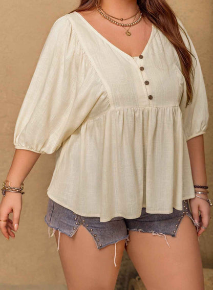Woman wearing a light-colored blouse with button details and denim shorts on a beige background