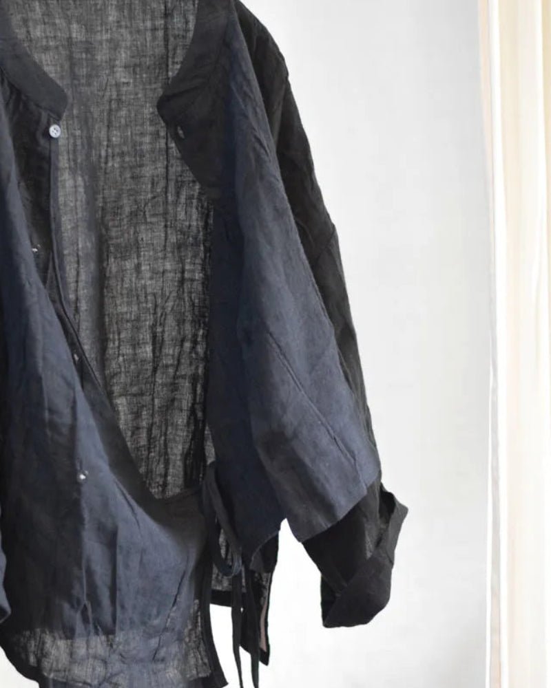 Dark gray and black layered shirt on a white background