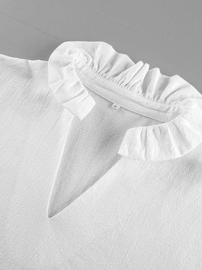 White ruffled collar on a light gray background