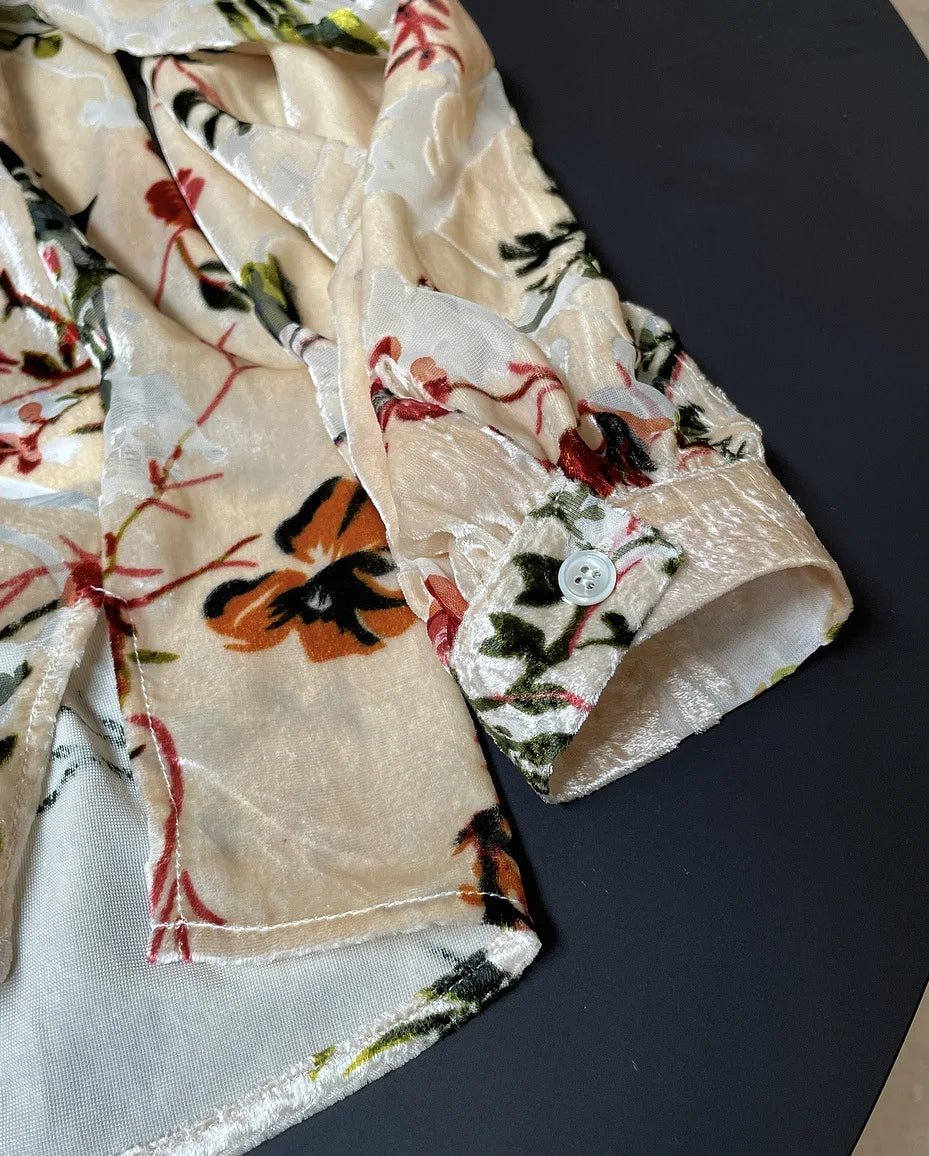 Floral patterned fabric with a button on a dark surface