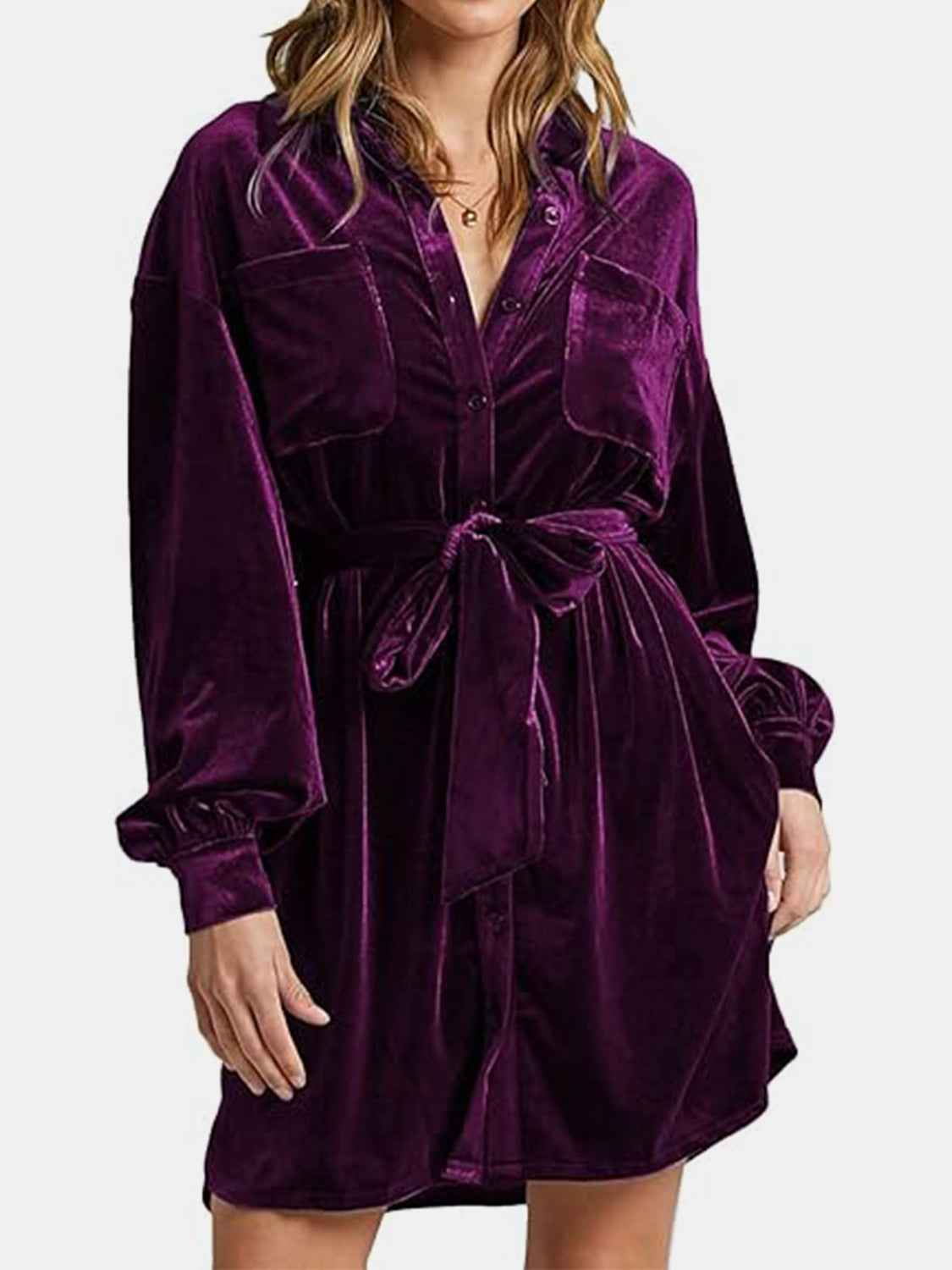 Purple velvet dress worn by a person on a white background