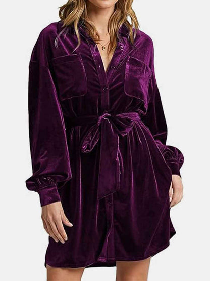 Purple velvet dress worn by a person on a white background