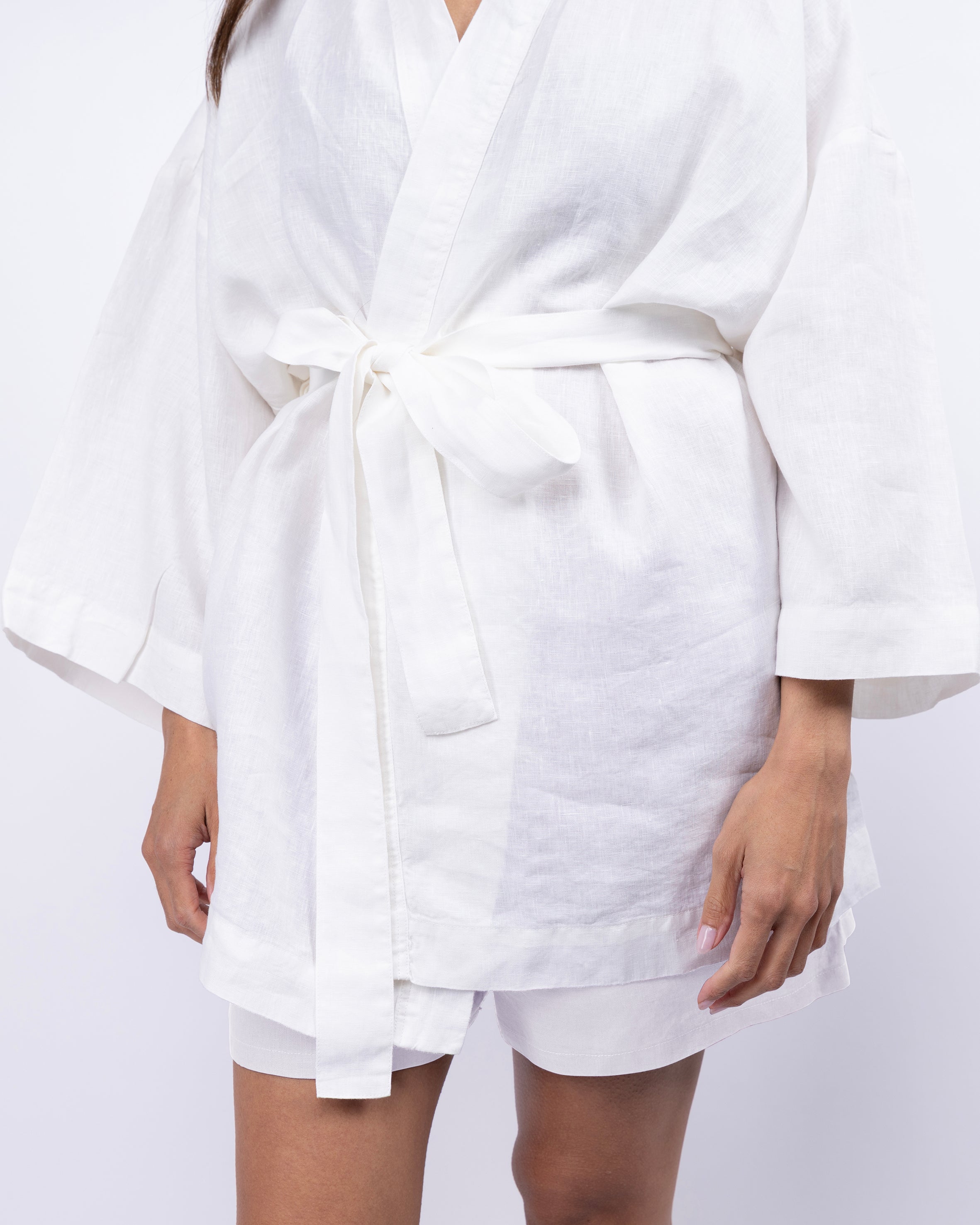 White robe with a belt worn by a person on a white background
