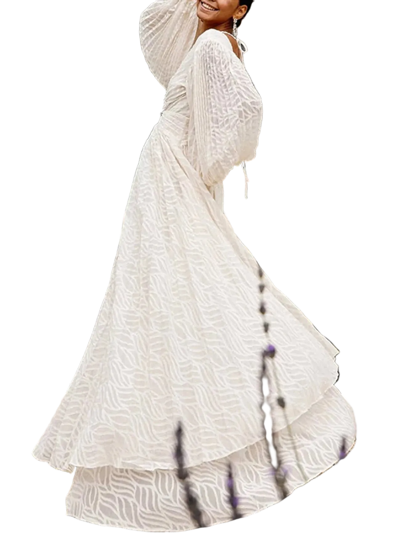A woman wearing a long, flowing white bohemian maxi dress with textured geometric patterns and a layered ruffle hem, shown in motion against a plain white background.