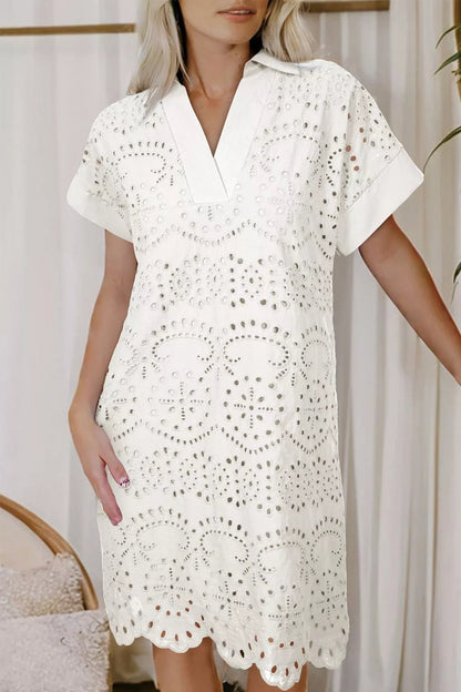 Woman wearing a white lace dress against a neutral background