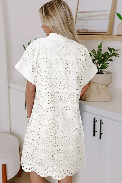 Woman wearing a white crochet cover-up in a bathroom setting